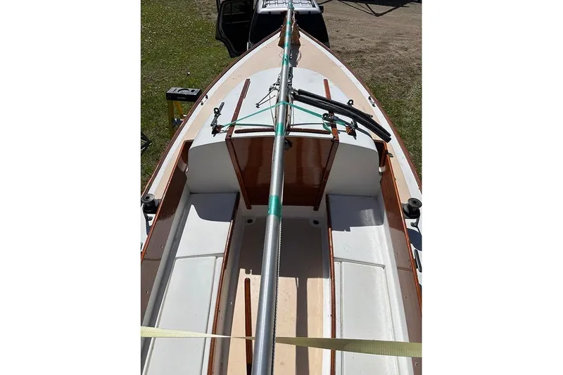 Slide: The Image of 1977 Cape Dory Typhoon Weekender sailboat interior with wooden accents and mast. - 5