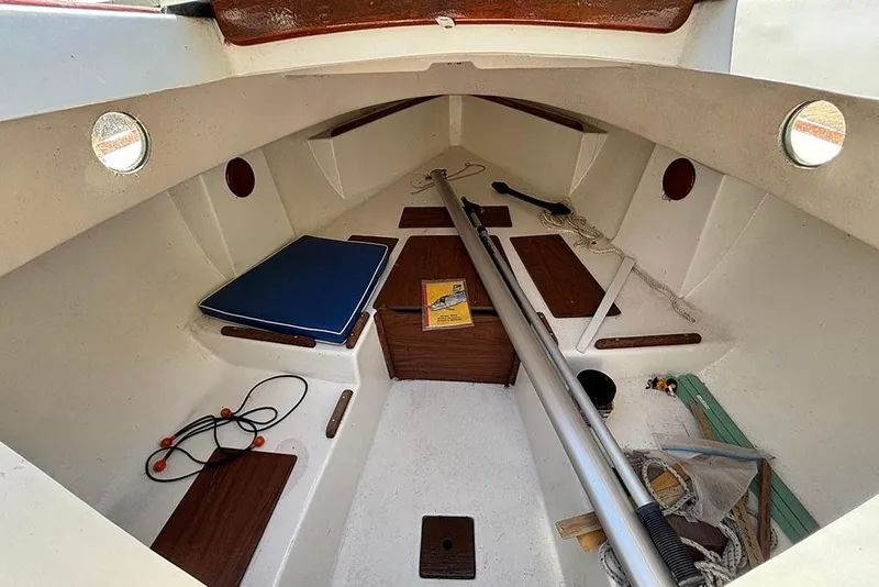 Slide: The Image of 1977 Cape Dory Typhoon Weekender cabin interior with nautical equipment and wooden accents. - 7