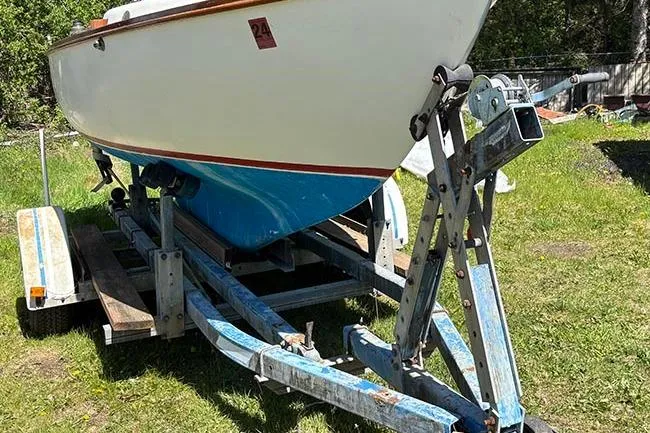 Slide: The Image of 1977 Cape Dory Typhoon Weekender sailboat on trailer, parked on grass. - 9