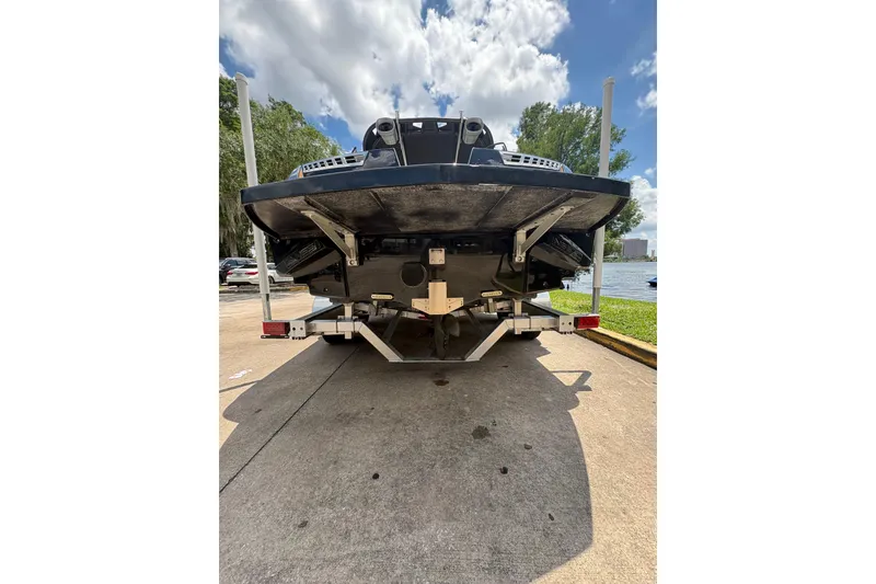 Slide: The Image of 2014 Nautique Super Air Nautique 210 boat on trailer, rear view, sunny day. - 2