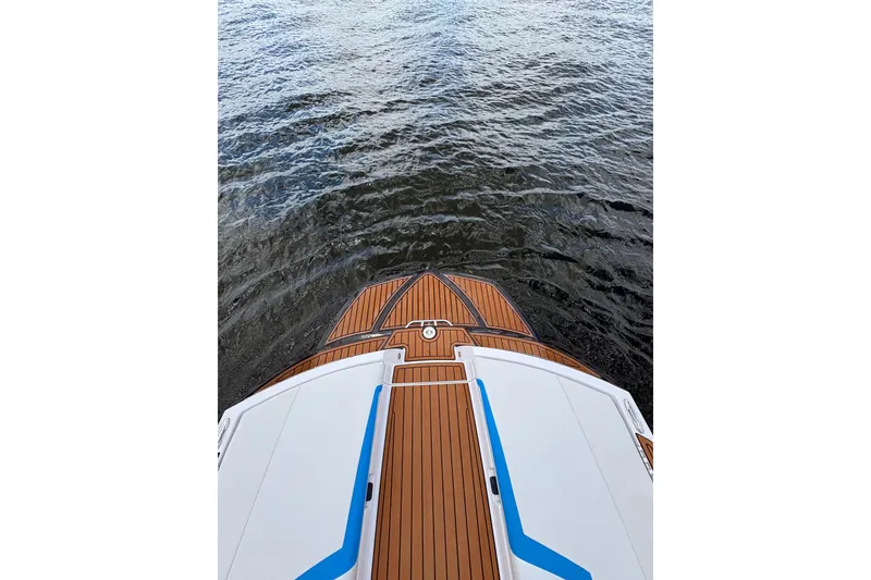 Slide: The Image of 2014 Nautique Super Air Nautique 210 boat deck overlooking water. - 3