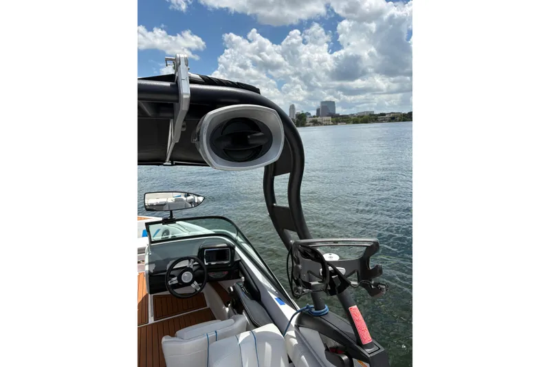 Slide: The Image of 2014 Nautique Super Air Nautique 210 boat interior with speaker and steering wheel. - 6
