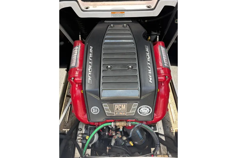 Slide: The Image of Engine of 2014 Nautique Super Air Nautique 210 boat, featuring PCM branding. - 9