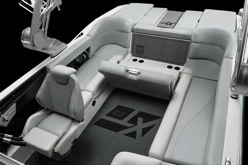 Slide: The Image of Manufacturer Provided Image: 2018 MasterCraft XT23 boat interior with gray seating and black carpet. - 18