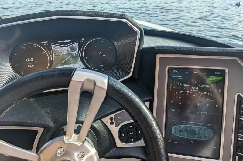 Slide: The Image of Dashboard of a 2018 MasterCraft XT23 boat with digital controls and steering wheel. - 6