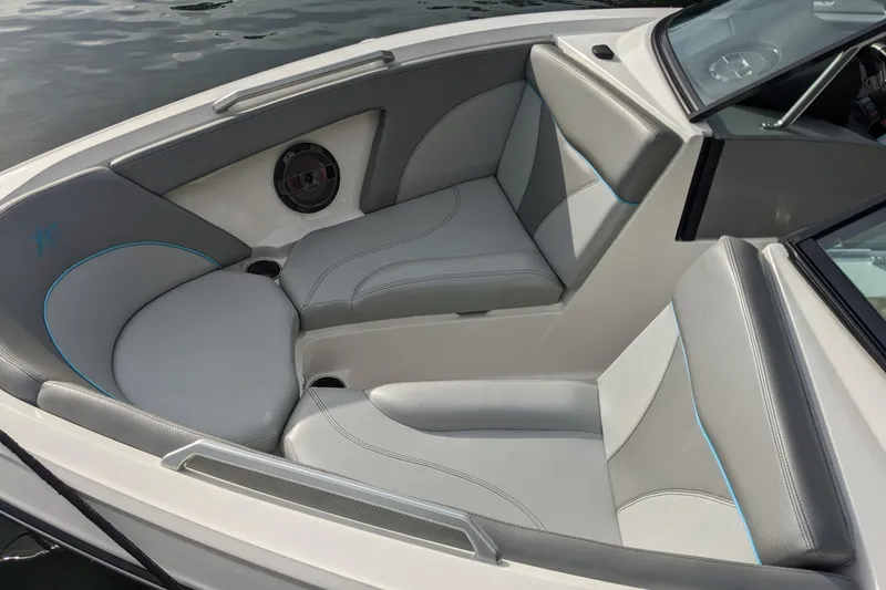 Slide: The Image of 2018 MasterCraft XT23 boat interior with gray seating and speaker detail. - 7