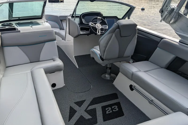 Slide: The Image of Interior of a 2018 MasterCraft XT23 boat with modern seating and steering wheel. - 8