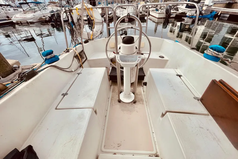Slide: The Image of Cockpit of a 1982 Newport 28 sailboat docked at a marina. - 2
