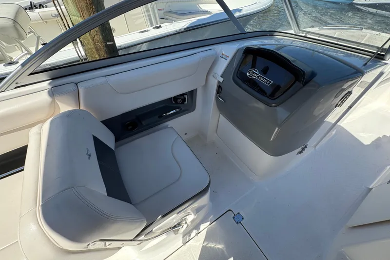 Slide: The Image of 2018 Chaparral 250 Suncoast boat interior with helm and seating area. - 15