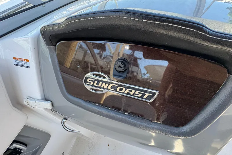 Slide: The Image of 2018 Chaparral 250 Suncoast dashboard with Suncoast emblem and sleek design. - 19