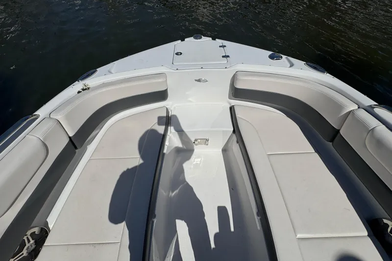 Slide: The Image of Bow seating area of 2018 Chaparral 250 Suncoast boat, featuring comfortable white cushions. - 23