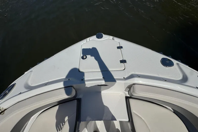 Slide: The Image of Bow view of 2018 Chaparral 250 Suncoast boat with shadow on deck. - 24