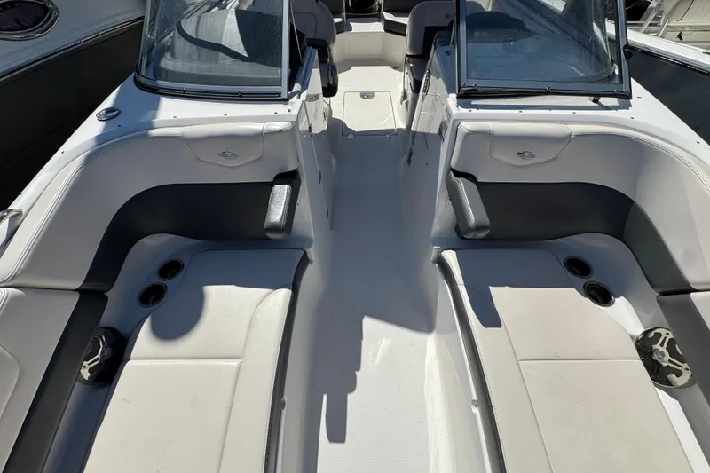 Slide: The Image of 2018 Chaparral 250 Suncoast boat interior with seating and cup holders. - 25