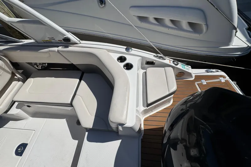 Slide: The Image of 2018 Chaparral 250 Suncoast boat interior with seating and teak flooring. - 5