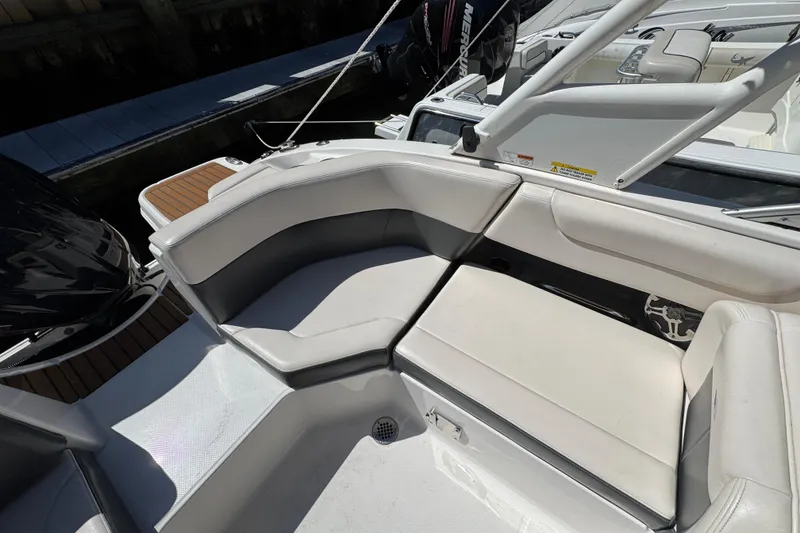Slide: The Image of 2018 Chaparral 250 Suncoast boat interior with white seating and sleek design. - 6