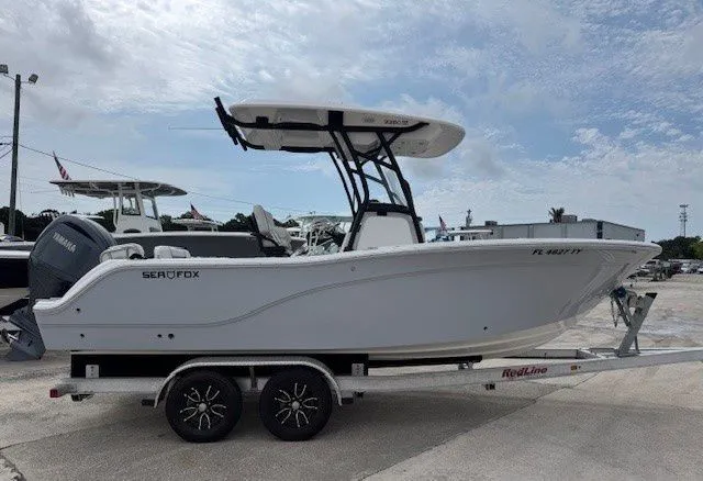 The Image of 2024 Sea Fox 228 Commander boat on trailer outdoors. - 1
