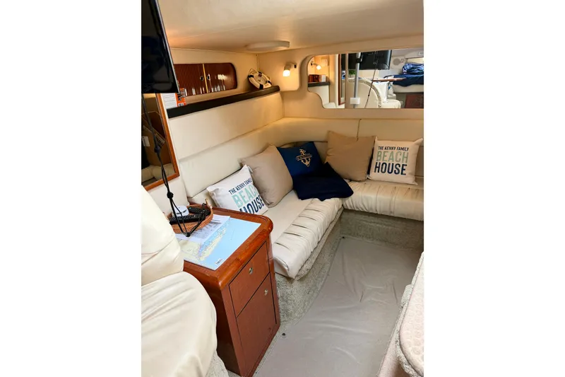 Slide: The Image of Interior of 2003 Sea Ray 340 Sundancer with cozy seating and nautical decor. - 10