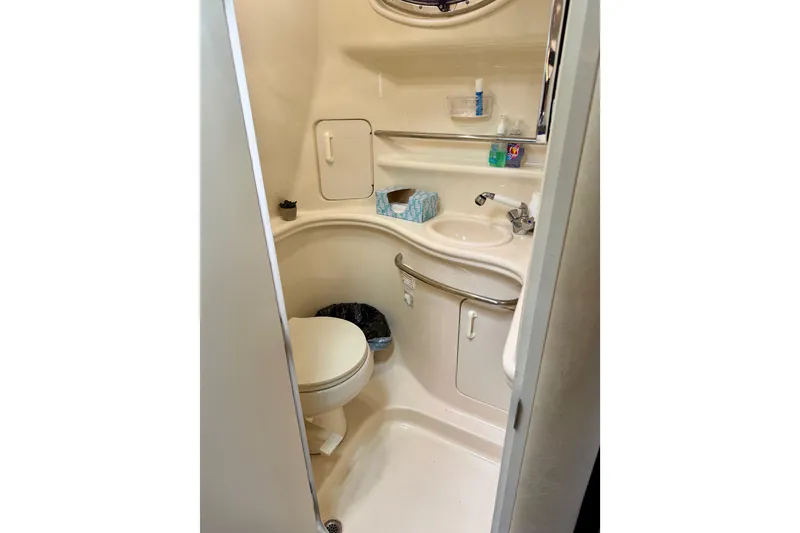 Slide: The Image of Compact bathroom in 2003 Sea Ray 340 Sundancer yacht, featuring toilet and sink. - 11
