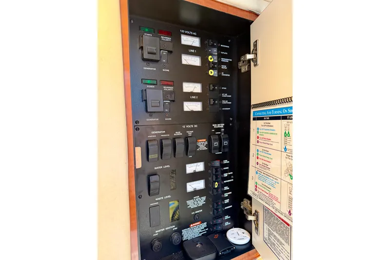 Slide: The Image of Electrical control panel of a 2003 Sea Ray 340 Sundancer boat, featuring switches and indicators. - 12