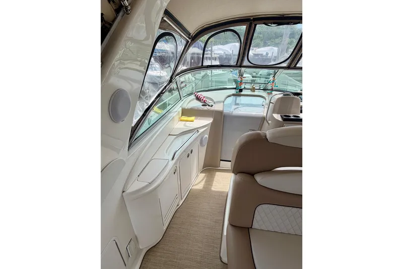 Slide: The Image of Interior of 2003 Sea Ray 340 Sundancer yacht with beige seating and cabinetry. - 3