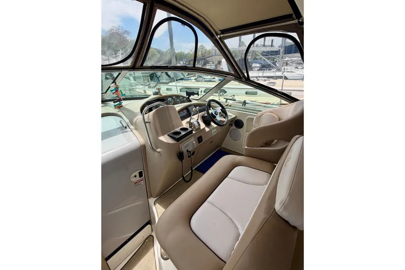Slide: The Image of Interior view of 2003 Sea Ray 340 Sundancer boat cockpit with steering wheel and seating. - 5