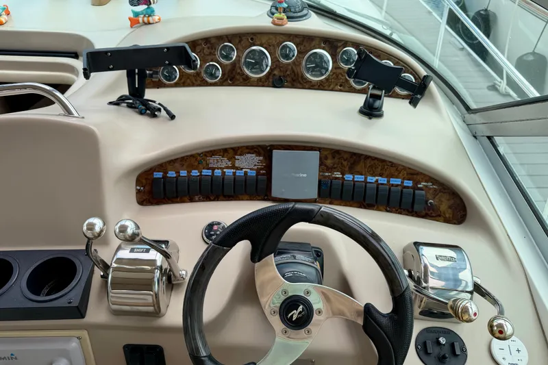 Slide: The Image of Helm of 2003 Sea Ray 340 Sundancer with steering wheel, controls, and gauges. - 6