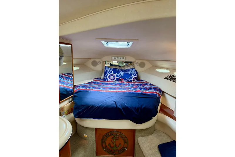 Slide: The Image of Cozy cabin interior of 2003 Sea Ray 340 Sundancer with nautical-themed bedding. - 7