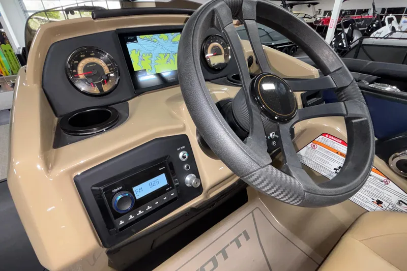 Slide: The Image of 2026 Evotti 525QL boat dashboard with steering wheel, GPS display, and radio controls. - 17