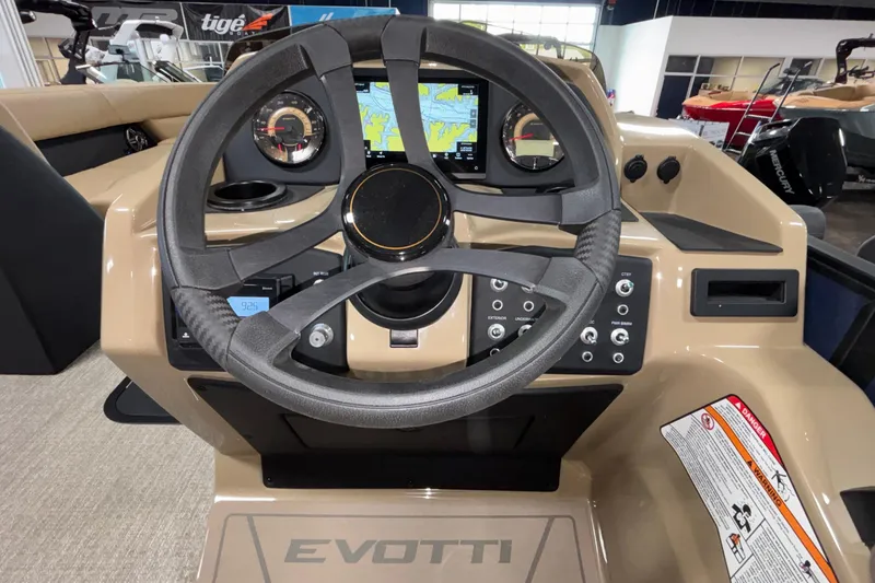 Slide: The Image of Steering console of 2026 Evotti 525QL boat with navigation display and controls. - 19