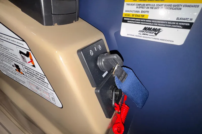 Slide: The Image of Key ignition panel of Evotti 525QL boat, 2026 model, with safety compliance labels. - 23