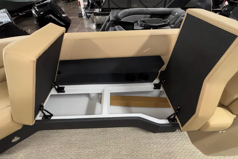 Slide: The Image of Open storage compartment in 2026 Evotti 525QL boat with beige seating. - 35