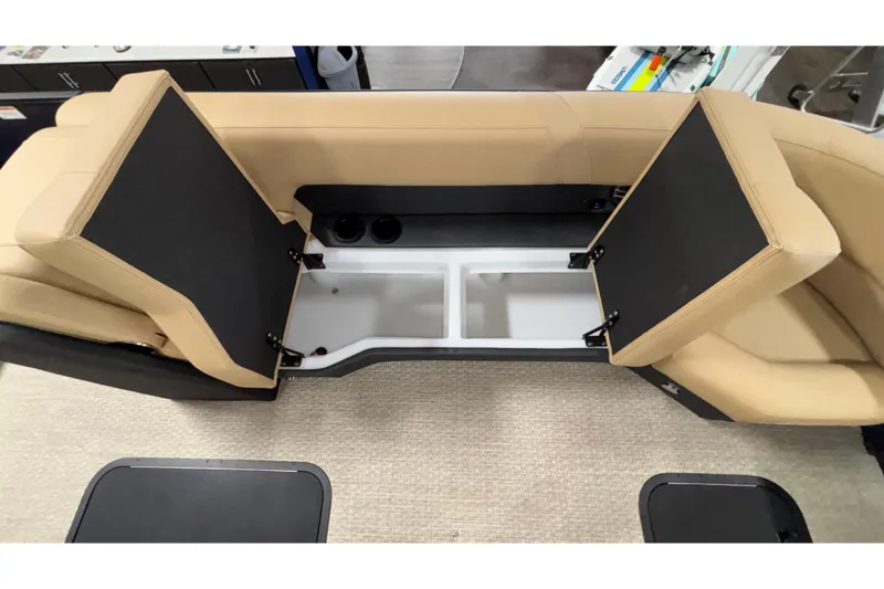 Slide: The Image of Open storage compartments in Evotti 525QL boat, 2026 model, with beige seating. - 37