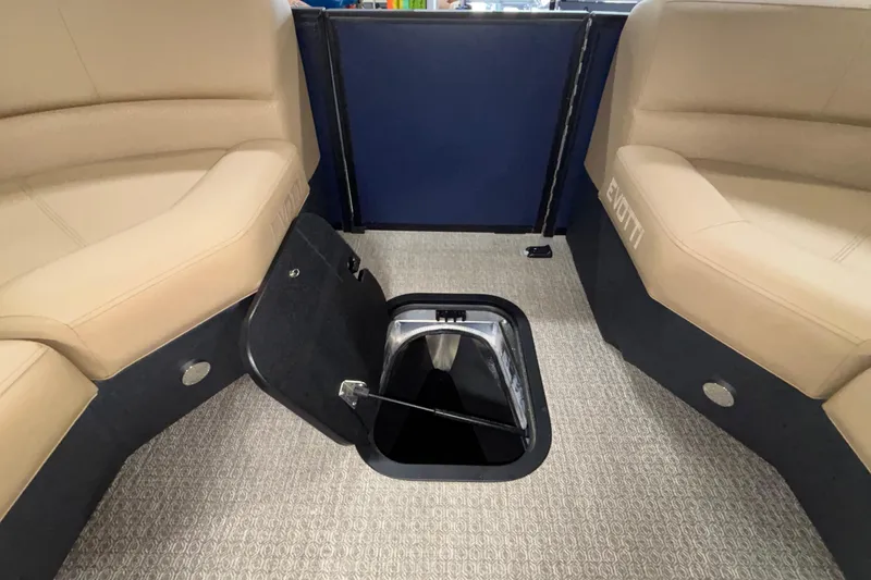 Slide: The Image of Interior of 2026 Evotti 525QL boat with open storage compartment and beige seating. - 39
