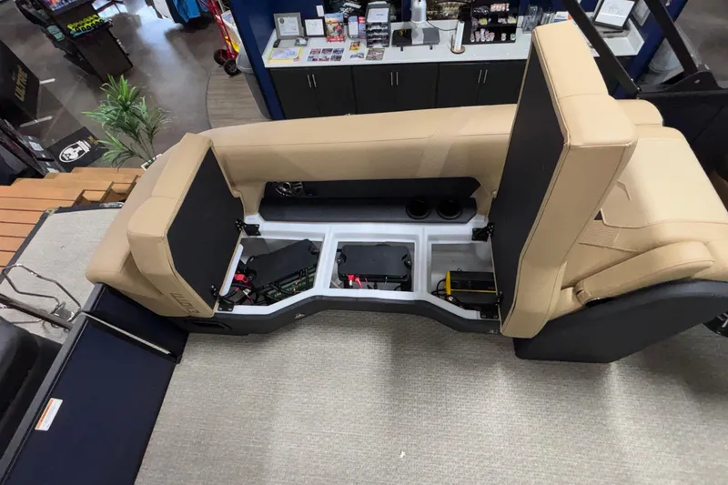 Slide: The Image of 2026 Evotti 525QL boat interior with open storage compartments and beige seating. - 40