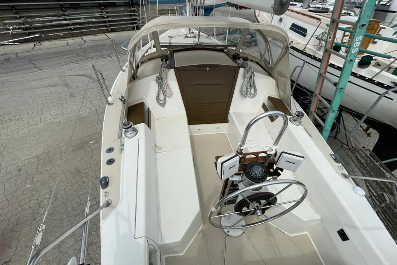 Slide: The Image of 1988 Catalina 30 sailboat cockpit with steering wheel and navigation equipment. - 10