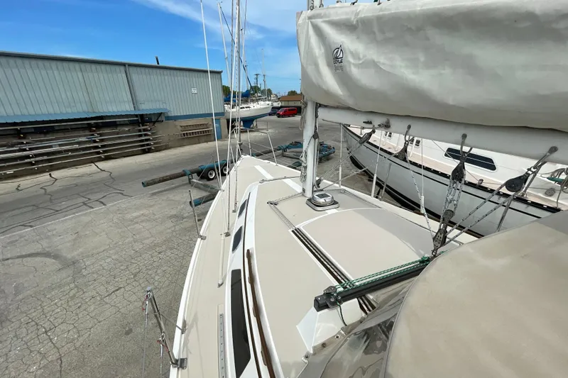 Slide: The Image of 1988 Catalina 30 sailboat docked in a marina, showcasing deck and rigging. - 13