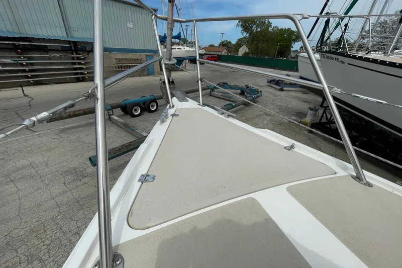 Slide: The Image of Bow view of a 1988 Catalina 30 sailboat in a marina setting. - 15