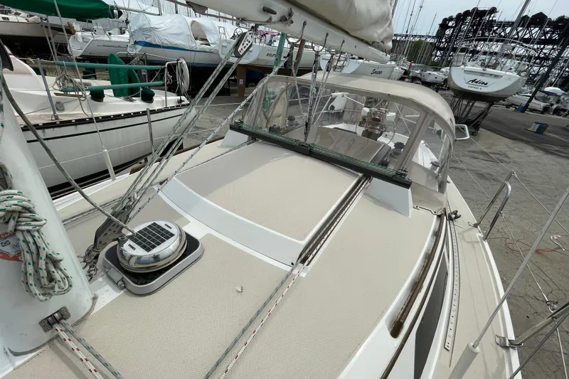 Slide: The Image of 1988 Catalina 30 sailboat on dock, showcasing deck and rigging details. - 16