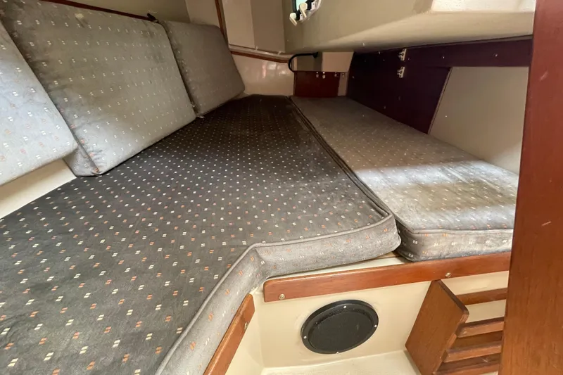 Slide: The Image of Interior cabin of a 1988 Catalina 30 sailboat with cushioned seating. - 22