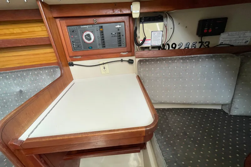 Slide: The Image of Interior of a 1988 Catalina 30 sailboat featuring a navigation station and control panel. - 23