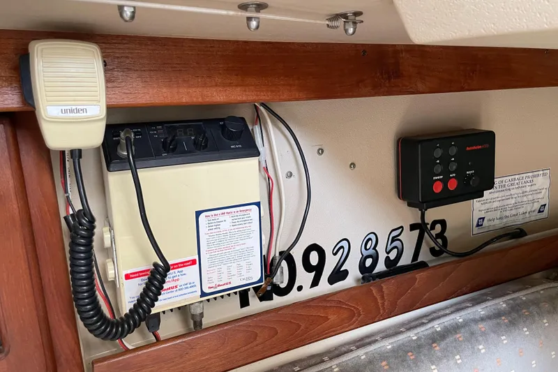 Slide: The Image of Interior of a 1988 Catalina 30 sailboat featuring communication equipment and control panel. - 24