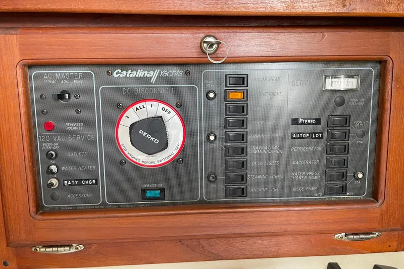 Slide: The Image of Control panel of a 1988 Catalina 30 yacht with various switches and dials. - 25
