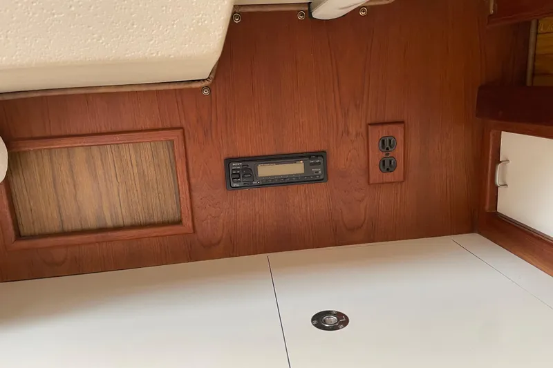 Slide: The Image of Interior of 1988 Catalina 30 sailboat with wood paneling and electrical outlets. - 26