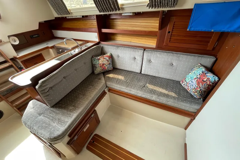 Slide: The Image of Interior of a 1988 Catalina 30 sailboat with cozy seating and colorful cushions. - 28