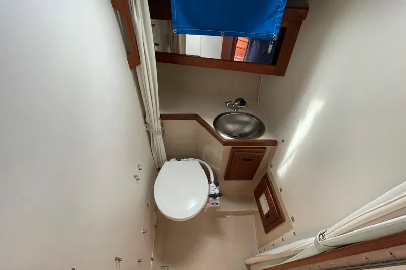 Slide: The Image of Interior of 1988 Catalina 30 sailboat bathroom with toilet and sink. - 30