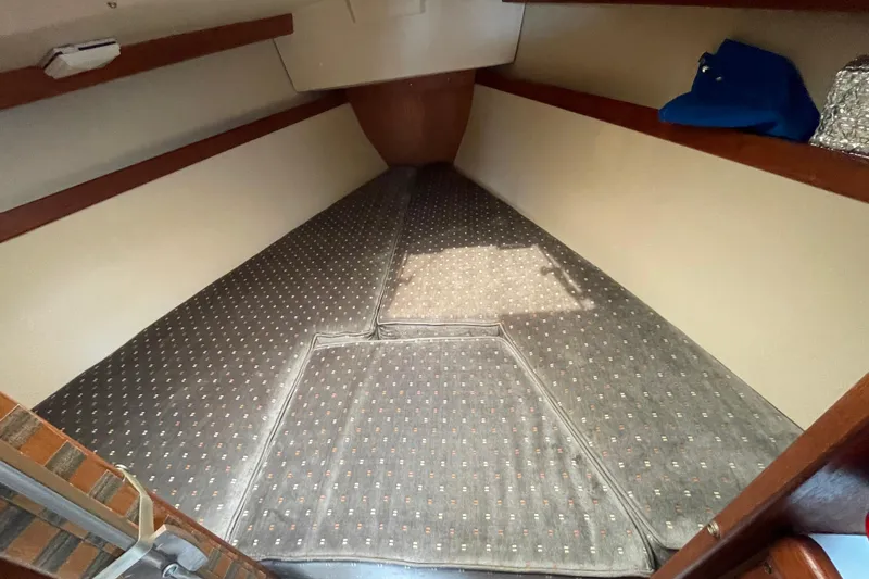 Slide: The Image of Interior cabin of a 1988 Catalina 30 sailboat with patterned cushions. - 31