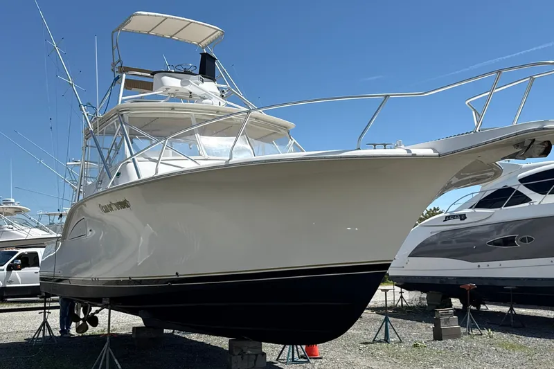 Slide: The Image of 2000 Dawson Yachts Express boat on stands, clear sky background. - 1