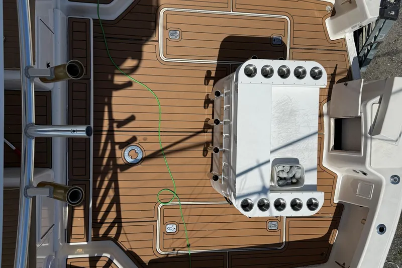 Slide: The Image of Deck of 2000 Dawson Yachts Express with fishing rod holders and storage compartments. - 10