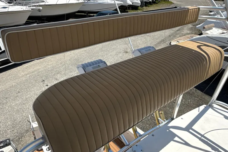 Slide: The Image of 2000 Dawson Yachts Express boat seating with tan upholstery, docked among other boats. - 12