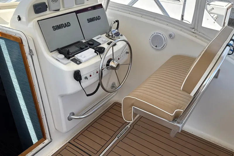 Slide: The Image of Helm of 2000 Dawson Yachts Express with Simrad navigation system and beige seating. - 13
